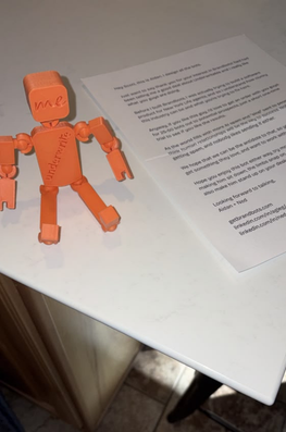 An orange BrandBot delivered alongside a personal letter