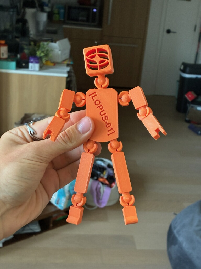An orange BrandBot held after delivery